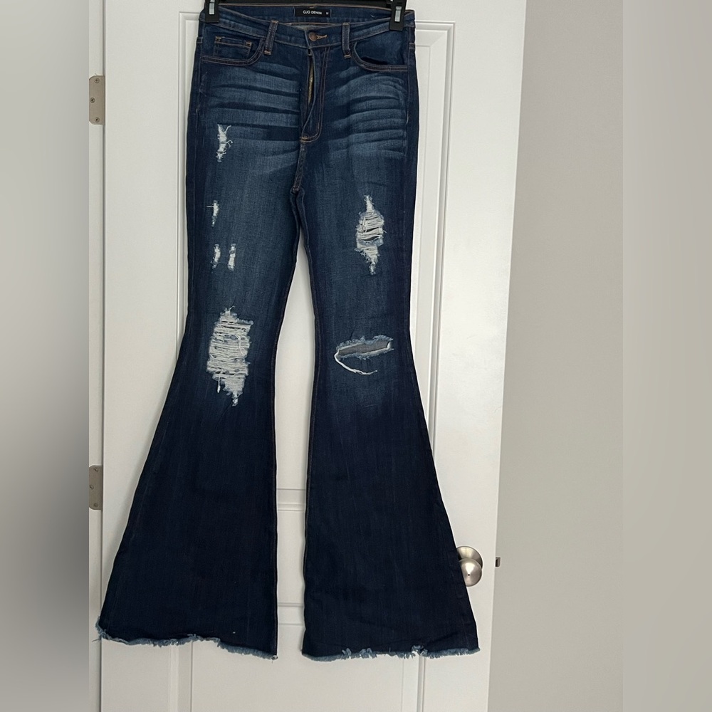 Distressed bell bottom jeans.